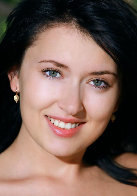 Foxy brunette young Ramina in shorts exposing small tits and spreading her legs outdoor